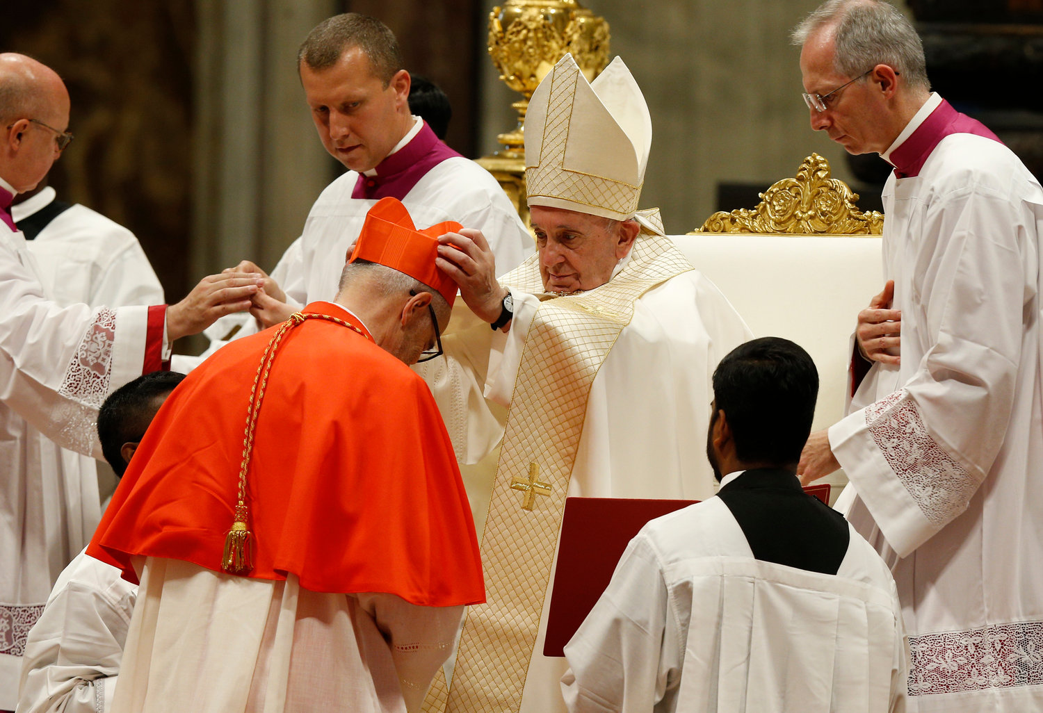 Pope Francis places a red biretta on new Canadian Cardinal Michael Czerny during a consistory for the creation of 13 new cardinals in St. Peter’s Basilica at the Vatican Oct. 5, 2019.